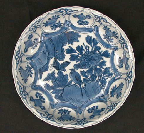 Chinese blue and white kraak dish, Wanli (1573-1619), flying birds and flowering peonies in a rocky landscape with  border roundels of peach and misc flowers.