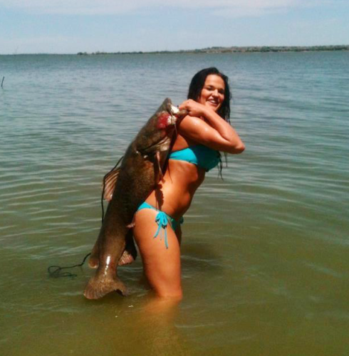 Lucy Millsap with a Flathead Catfish she captured by "noodling"