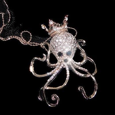 A rhinestone octopus wearing a crown (jewelry pendant)